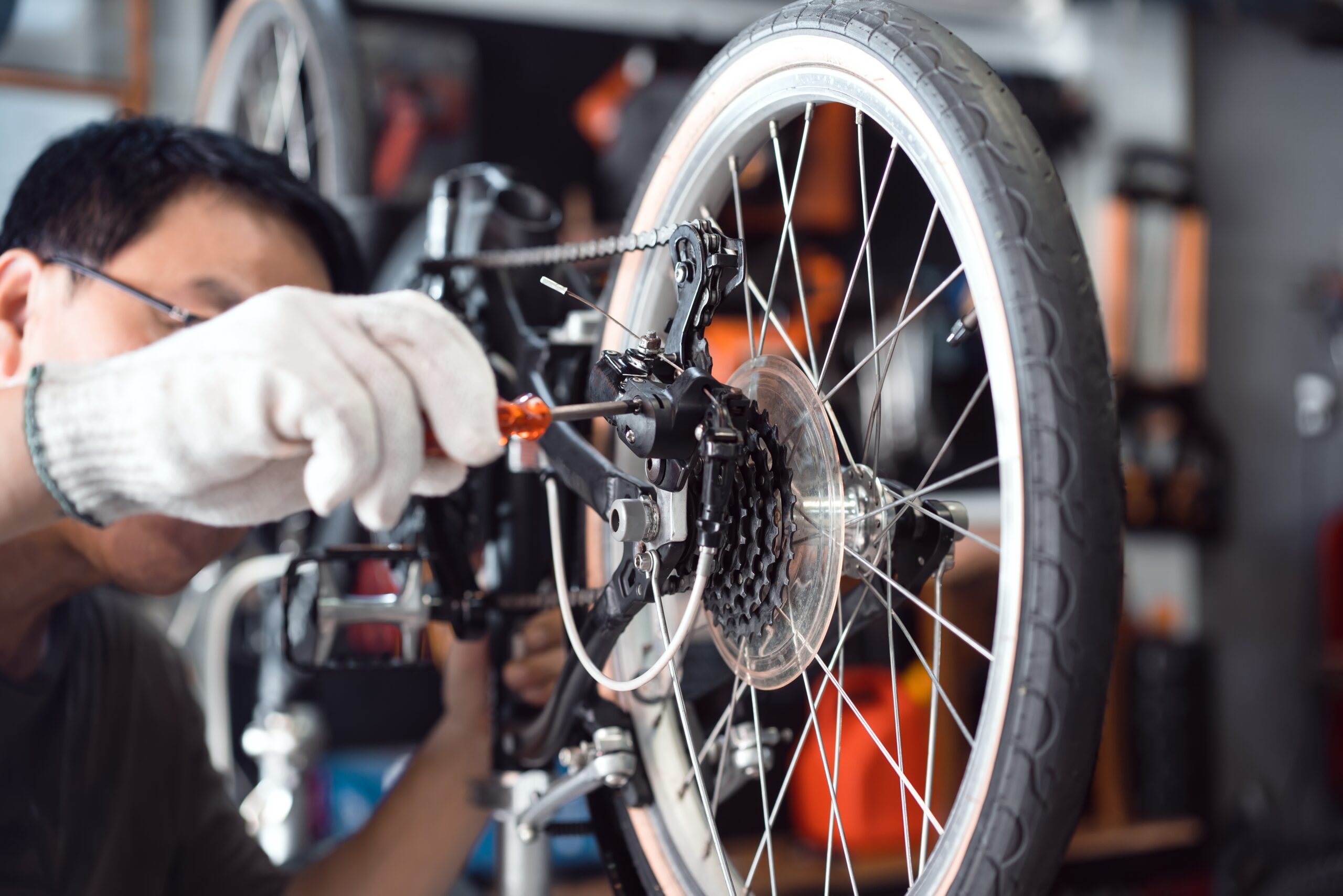 Bike,Mechanic,Adjust,Rear,Derailleur,And,Repair,Bicycle,In,Workshop.